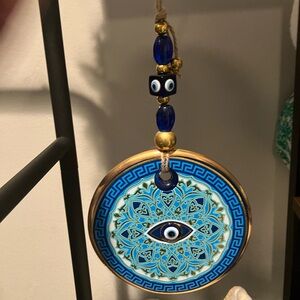 Greek glass evil eye medallion on jute string
Approx 6in wide x 12in long